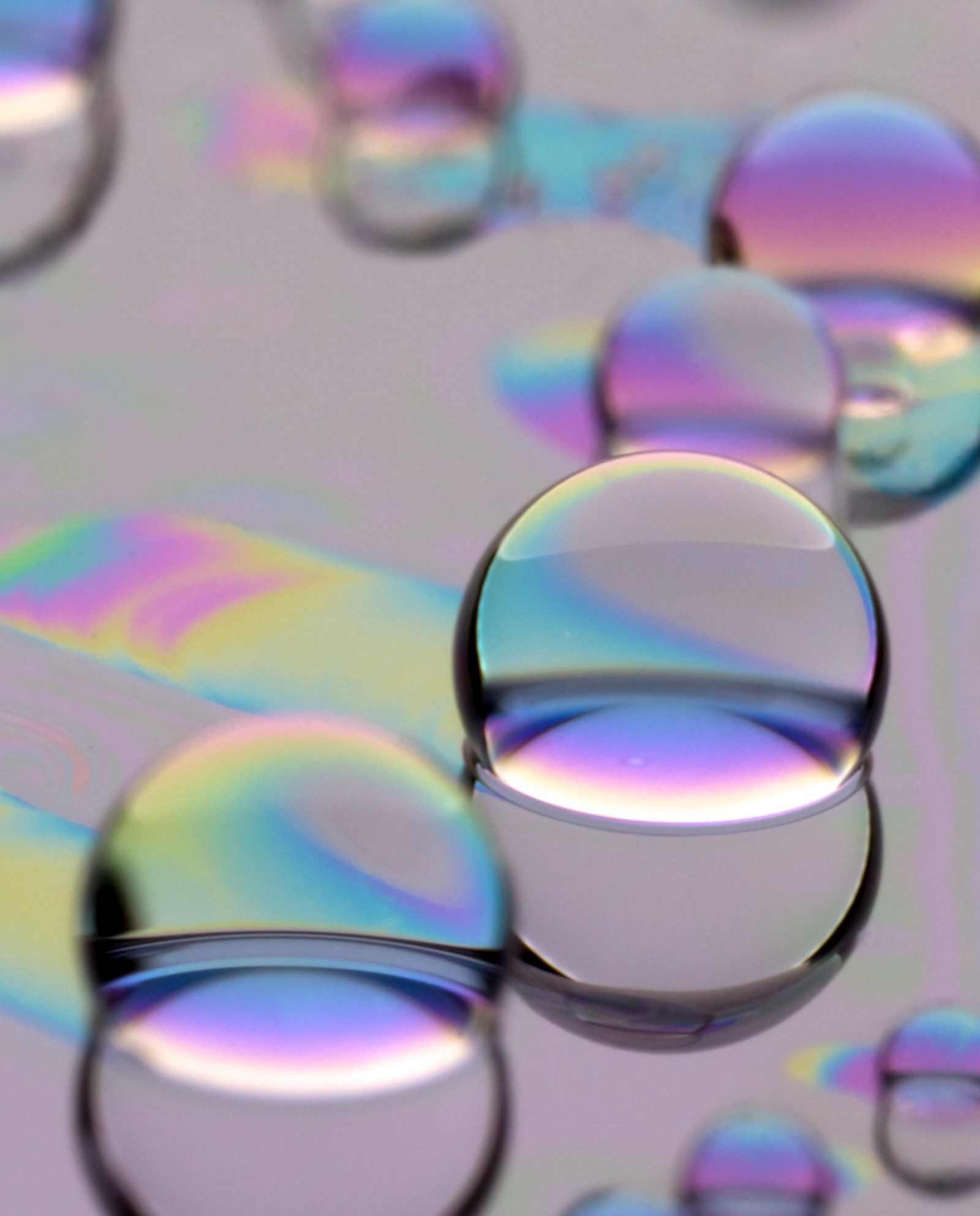 Iridescent oil droplets clustering on a lubricated surface.